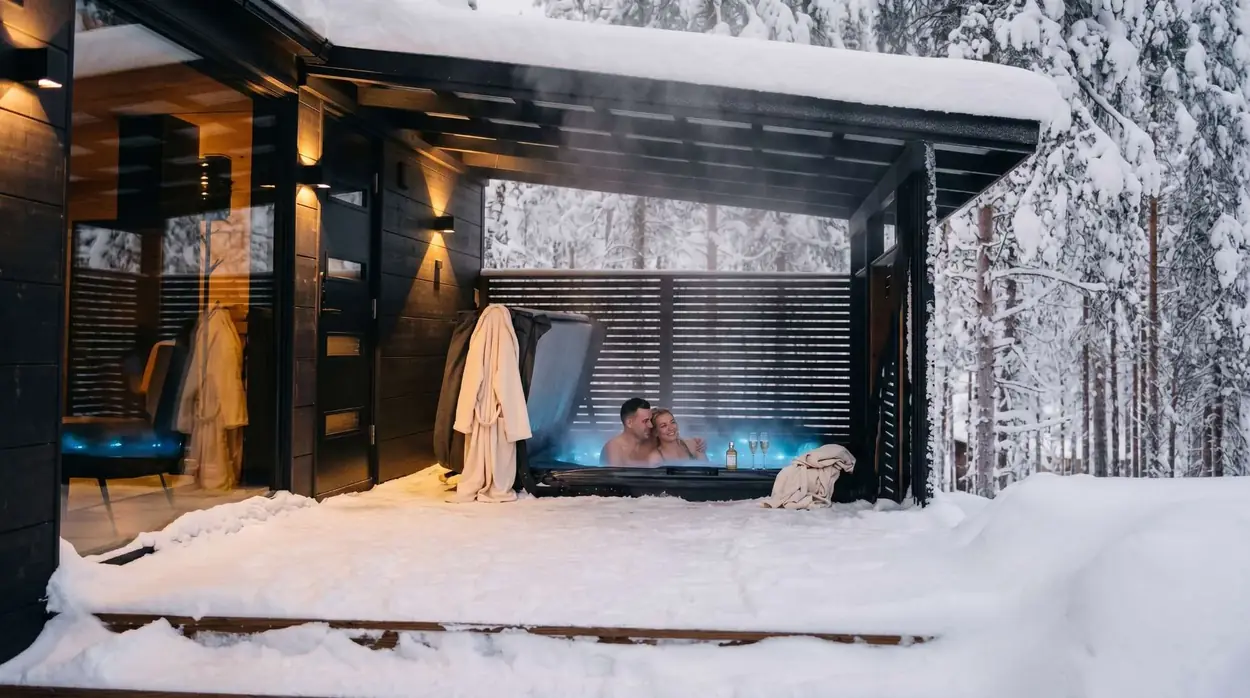 Private outdoor jacuzzi with the snowy forest beyond